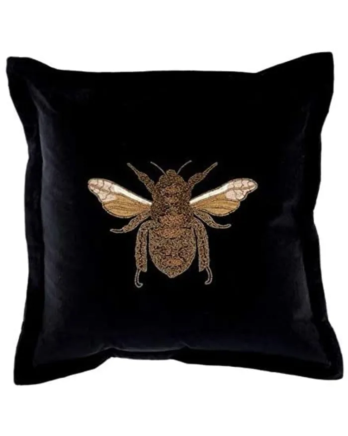 a black pillow with a bee embroidery on it